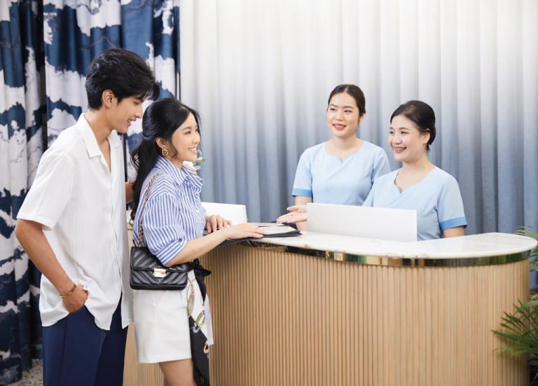 Receptionists Stand And Greet Couple At Lobby Desk Bangkok Spa Siam SQ1