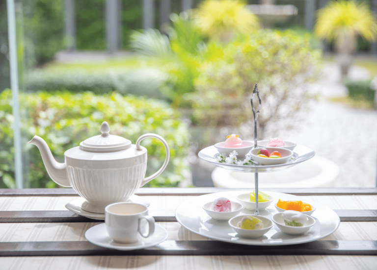 Spa High Tea Set, White China Teapot, Teacup, And Two Tier Dessert Stand On Treasure Chest