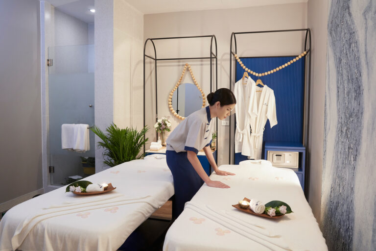 Professional spa therapist preparing treatment room Bangkok spa