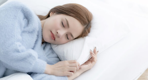 beautiful asian woman casual dress sleep well on white bed daylight morning time