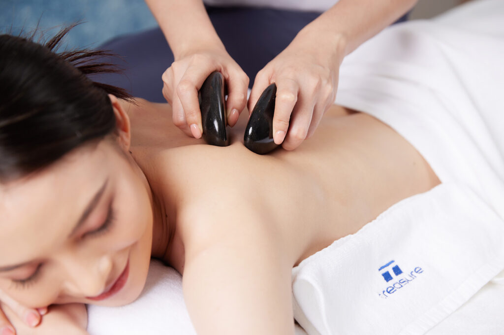 Hot stone massage Bangkok heated basalt stones thermal therapy Treasure Spa Siam muscle relaxation